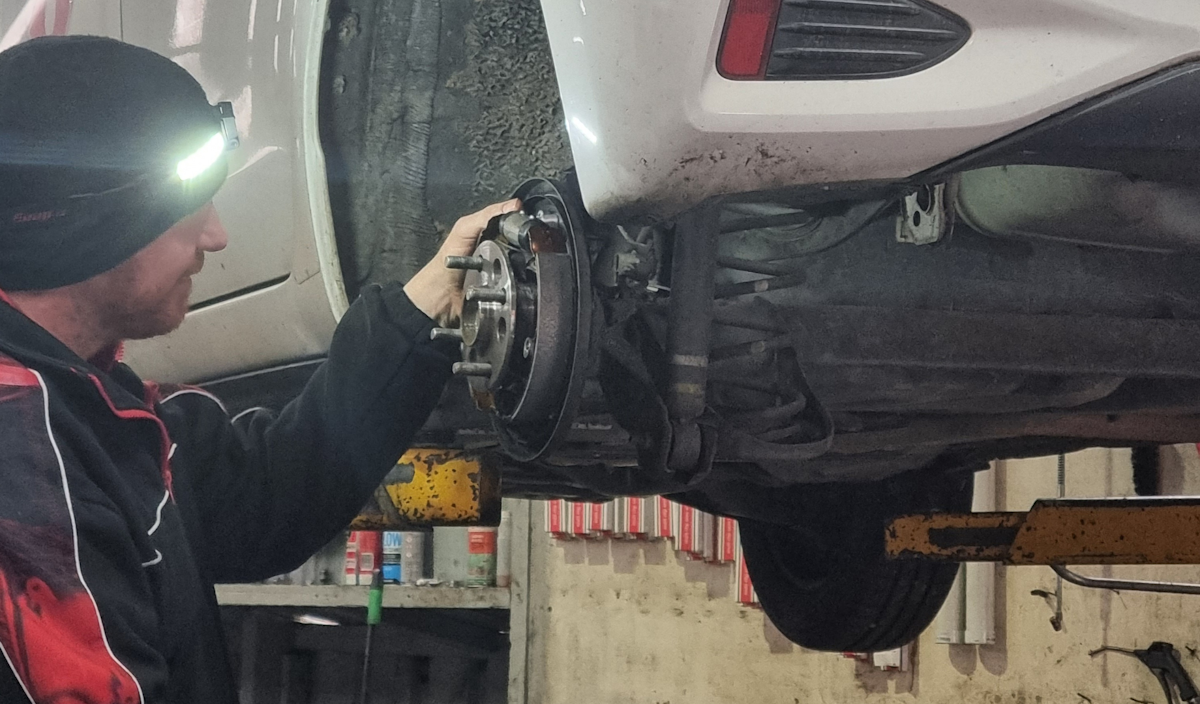 Automotive technician performing a brake service at MD Auto